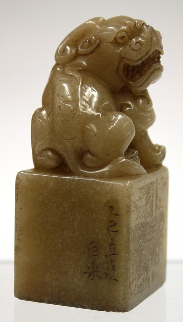 Chinese Soapstone Seal, Fu-lion: Chinese carved soapstone seal, the short rectangular shaft surmounted by a seated chilong picked out from a tan colored matrix with icy inclusions, one face incised 'jisi li xia, Ju Lai', (=summer of