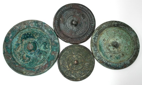 Chinese Bronze Mirrors: (lot of 4) Chinese cast bronze mirrors, including: a Han style disk with a classic scroll band, 3.5''; an Eastern Han style work with dragons, 3''d; a Han or Song style disk with 'Lu' surname, 2.75''d