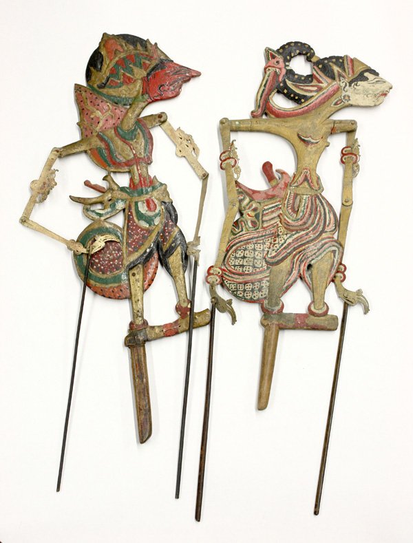 Indonesian Shadow Puppets: (lot of 2) Indonesian shadow puppets, each depicting a hero from the Ramayama, the polychromed wood bodies with painted leather/paper arms attached to slender rods (wear, retouched), 19'' and 21''h