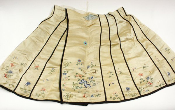 Chinese Silk Skirt: Chinese satin silk skirt, the yellow ground embroidered with panels of bats and butterflies fluttering among various stylized blossoms, with black trim (altered, some shredding, added embroidery), 26.