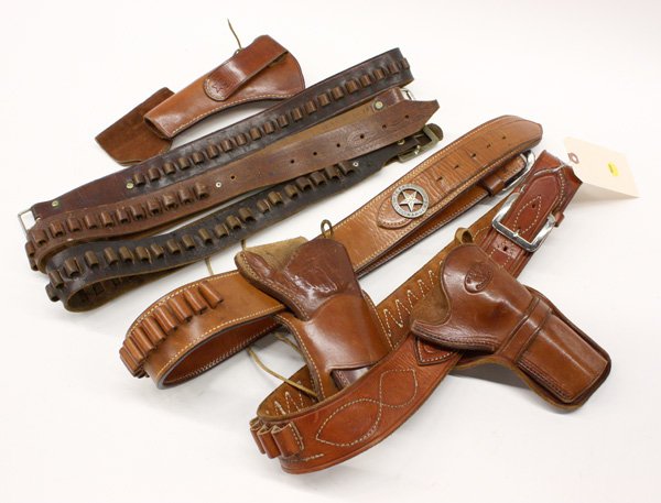 Vintage leather belts and holsters: (lot of 7) Vintage leather belts and holsters including three ammunition belts, one ammunition belt with holster, one leather belt with holster, and two unattached holsters, makers including Bianchi a
