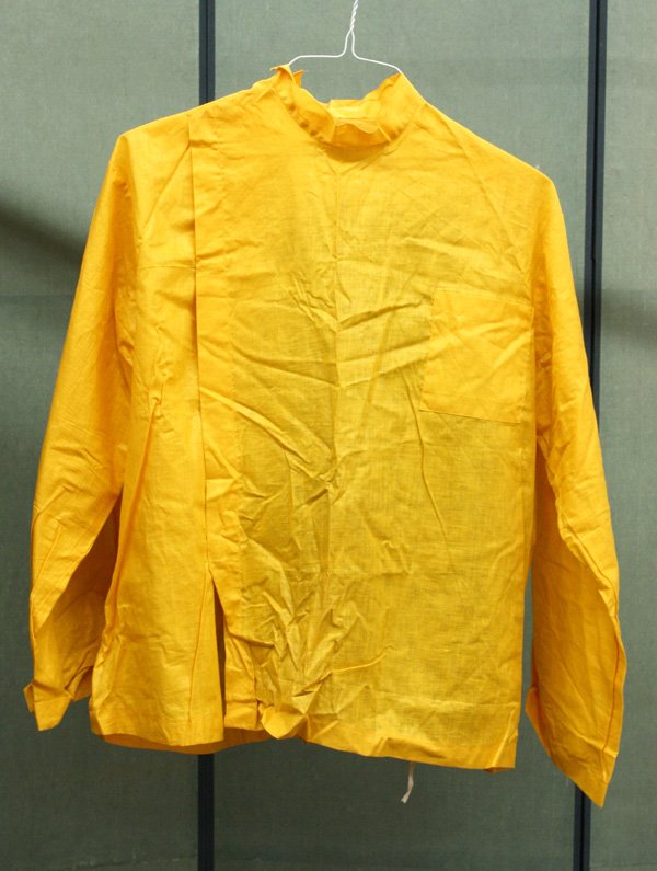 Vintage sporting clothing: (lot of 2) Group of vintage sporting clothing consisting of a Men's Cornell cheerleading uniform including a jacket and cap; together with yellow and black linen baseball outfit. Provenance: Cornell m