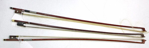 Violin bows: (lot of 3) Grouping of full sized violin bows, including one with an ivory tightener, two with silver