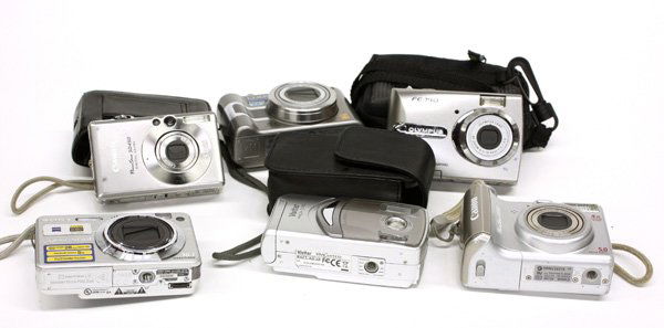 Digital cameras: (lot of 6) Bag lot of electronics including an Olympus digital camera, a Canon Powershot SD450 digital camera, Panasonic Lumix digital camera, a Sony Cybershot Carl Zeiss digital camera, a Canon Power