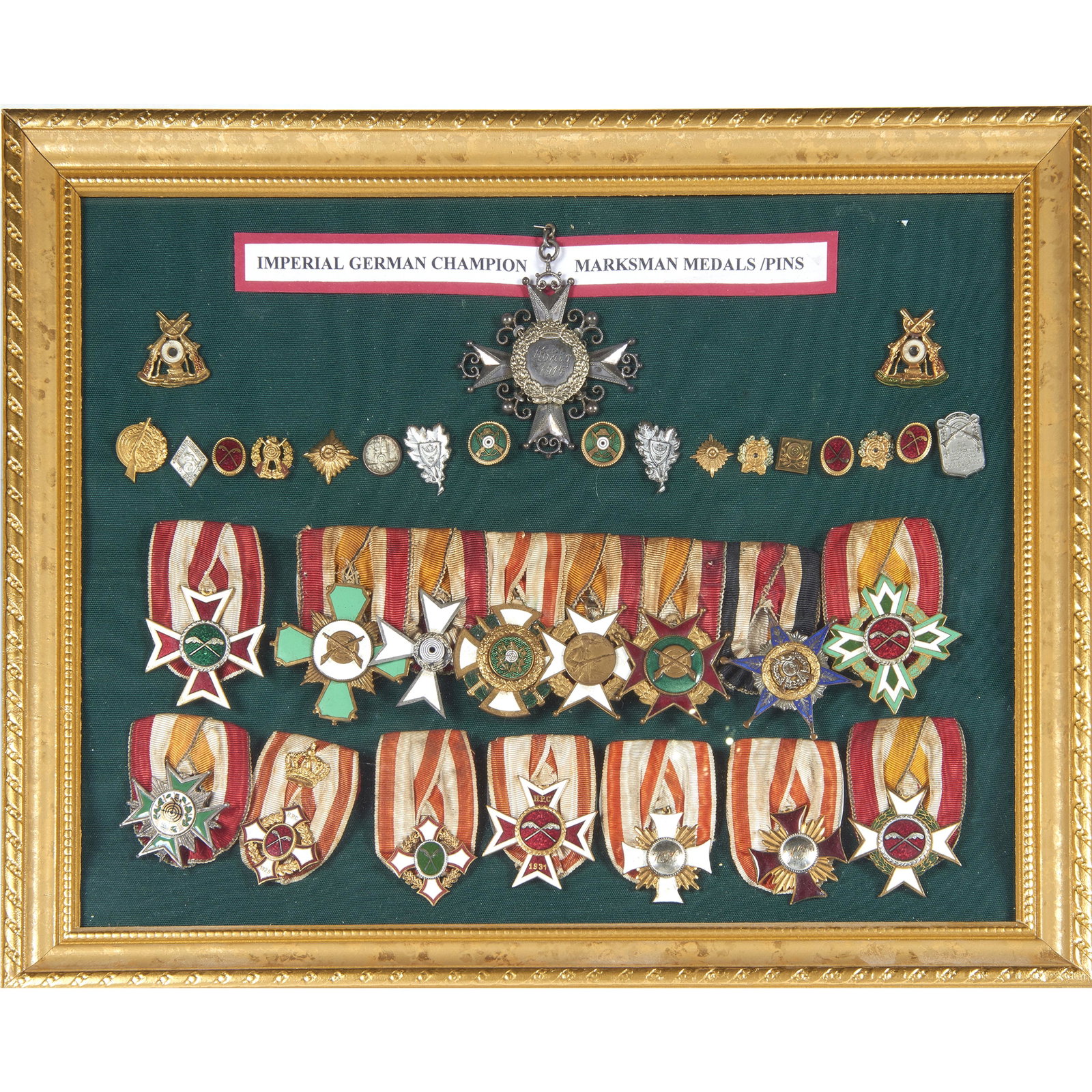Frame (35) German Champion Marksman enameled medals and: A framed collection of (35) Imperial German Champion Marksman medals and pins: (16) enameled cross or star form medals and (19) pins, overall 15"w x 12.5"h, Provenance: The Holt Military Museum, Lafay