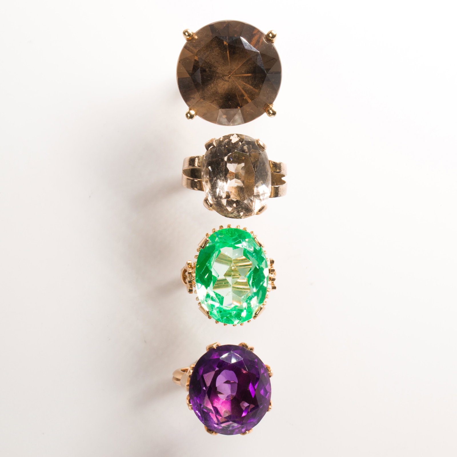 A group of gemstone and fourteen karat white or yellow: A group of gemstone and fourteen karat white or yellow gold rings including an oval-cut green synthetic spinel, measuring approximately 20.00 x 15.20 x 8.00 mm; an oval-cut amethyst, measuring approxi