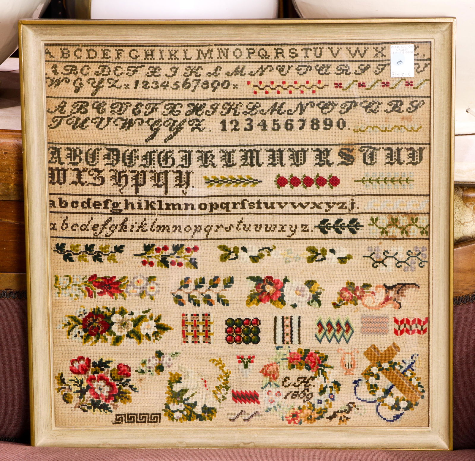 An embroidered sampler dated 1869 (1 of 1)