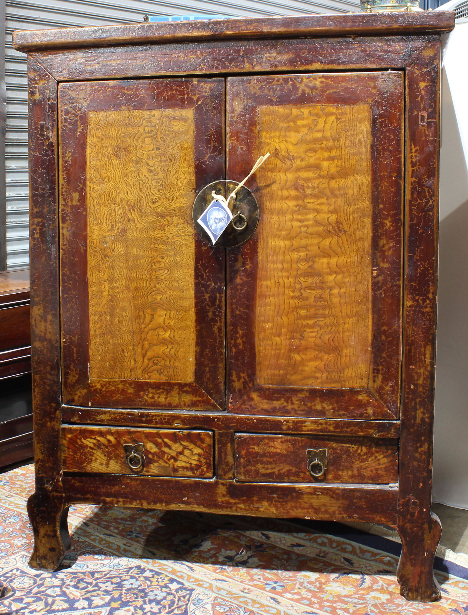 Chinese red lacquered hardwood cabinet: Chinese red lacquered hardwood cabinet, with twin burl paneled doors, 44"h x 34"w x 23"d