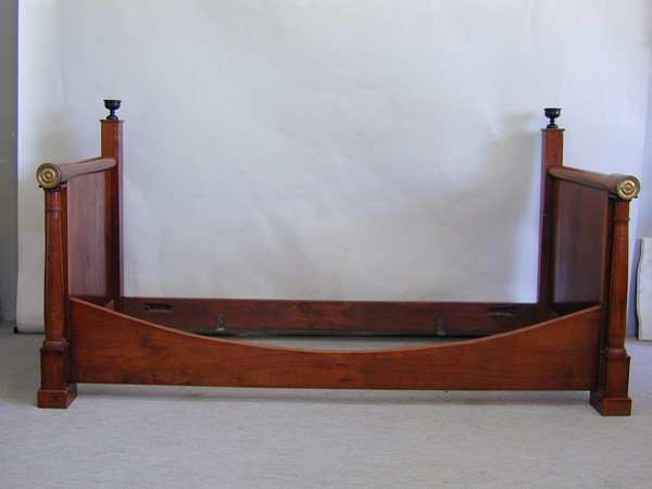 Empire walnut and cherry daybed, circa 1810: Empire walnut and cherry daybed, circa 1810, having ebony finials, column pilasters and bronze capped arms, rising on blocked feet, 41''h x 77''w x 37.5''d