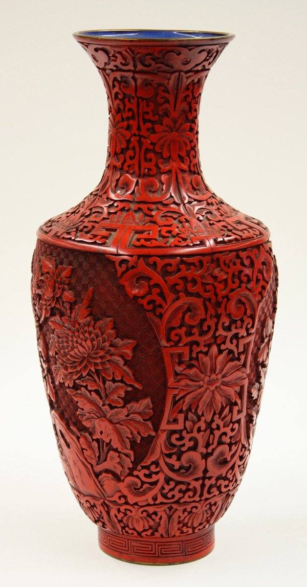 Chinese Large Cinnabar Lacquer Vase: Chinese large cinnabar lacquer baluster vase, decorated with two large floral panel on a diaper-lozenge ground and reserved on a dense ground of scrolling tendrils and stylized lotus extending over th