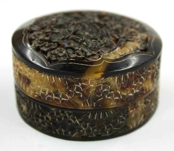 Chinese Carved Tortoise Shell Box: Chinese carved circular tortoise shell covered box, the lid pierced with three bats flying amid cloud scrolls in a shaped reserve, the sides incised with prunus and bamboo motif, 2.25''dia
