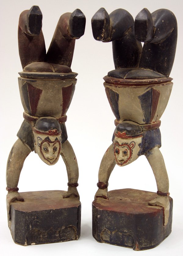 Chinese Carved Wood Monkey King: Pair of Chinese pigment decorated wood carvings, each featuring the Monkey King in a handstand position above a rectangular plinth, 13.5''h