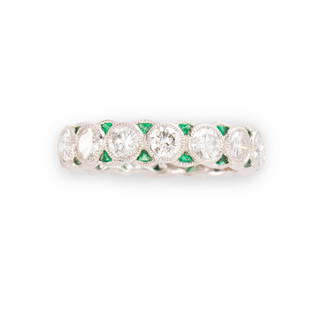 A diamond, emerald and platinum ring: A diamond, emerald and platinum ringa concentric design of round brilliant-cut diamonds, within millegrained bezels, accented by triangular-cut emeralds; estimated total diamond weight: 2.40 carats.