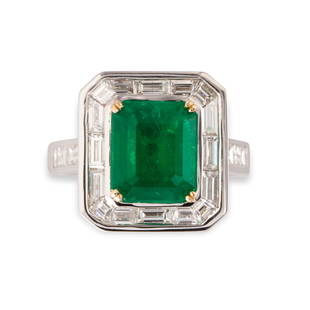 An emerald, diamond and eighteen karat white gold ring: An emerald, diamond and eighteen karat white gold ringdesigned as an octagonal step-cut emerald, weighing 4.24 carats, framed by a channel of baguette-cut diamonds; estimated total diamond weight: