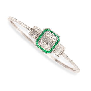 An emerald, diamond and fourteen karat white gold: An emerald, diamond and fourteen karat white gold bangle braceletdesigned as a cluster of baguette, radiant and round brilliant-cut diamonds, framed by a channel of calibré-cut emeralds, further