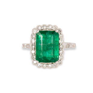 An emerald, diamond and eighteen karat white gold ring: An emerald, diamond and eighteen karat white gold ringdesigned as a step-cut emerald, weighing approximately 3.10 carats, within millegrained scalloped setting, set with single-cut diamonds. 3.2 dwt;