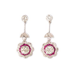 A pair of diamond, ruby and platinum drop earrings: A pair of diamond, ruby and platinum drop earringsof floriform design, each with a round brilliant-cut diamond, weighing approximately 0.50 or 0.60 carat, framed by ruby and diamond petals. 4.8 dwt;