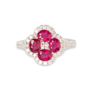 A ruby, diamond and fourteen karat white gold ring: A ruby, diamond and fourteen karat white gold ringdesigned as a cluster of oval-cut rubies, each weighing approximately 1.00 carats, within scalloped round brilliant-cut diamond frame. 3.4 dwt; size: