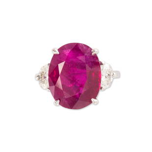 A no-heat ruby and diamond ring: A no-heat ruby and diamond ringdesigned as an oval-mixed cut ruby, weighing 10.83 carats, four-prong set between a pair of oval-cut diamonds, each weighing approximately 0.30 carat, in eighteen karat