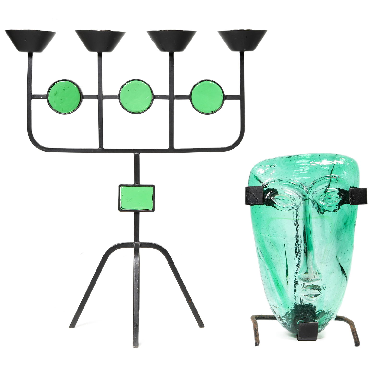An Erik Hoglund for Kosta Boda glass face mask: An Erik Hoglund for Kosta Boda glass face mask, executed in green, and rising on custom stand, together with a Gunnar Ander candelabra, executed in enameled iron, having four lights above three green