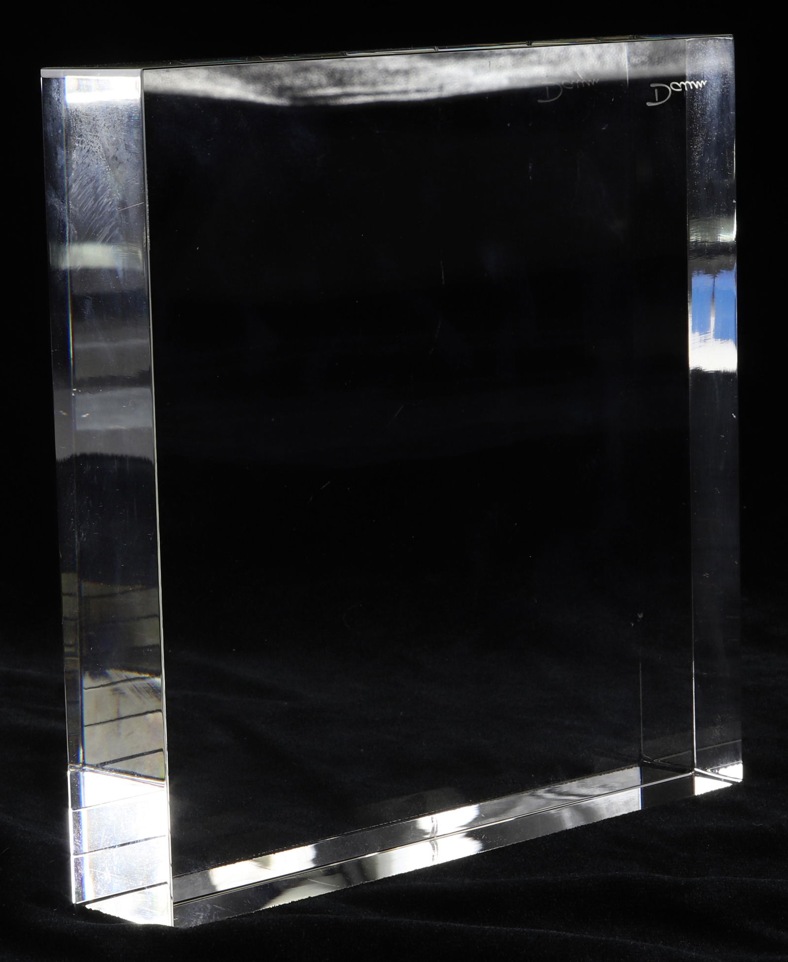 A Daum clear glass sculpture: Daum clear glass sculpture, having a rectangular form, with etched signiature, 7"h x 7"w