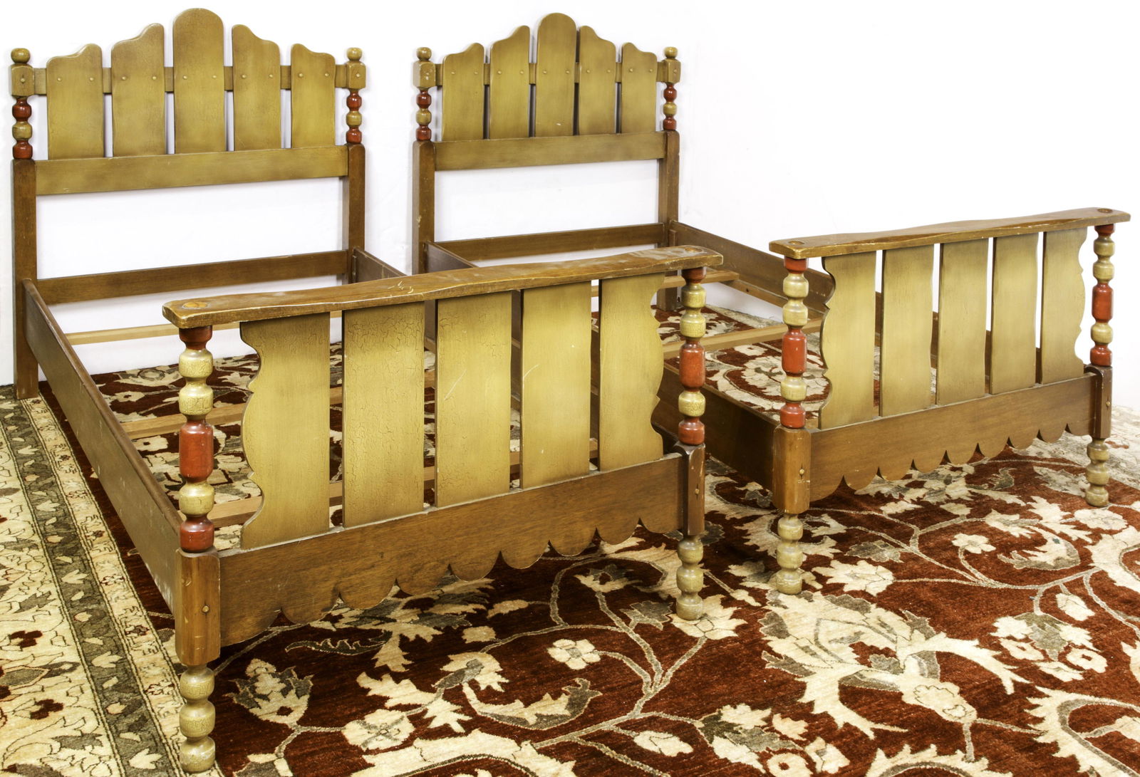 A pair of Spanish Revival Del Rey twin beds: A pair of Spanish Revival Del Rey twin beds, each having a crackle finish with slatted headboards and footboards, Ostensibly exhibited and purchased at the Golden Gate International Exposition held in