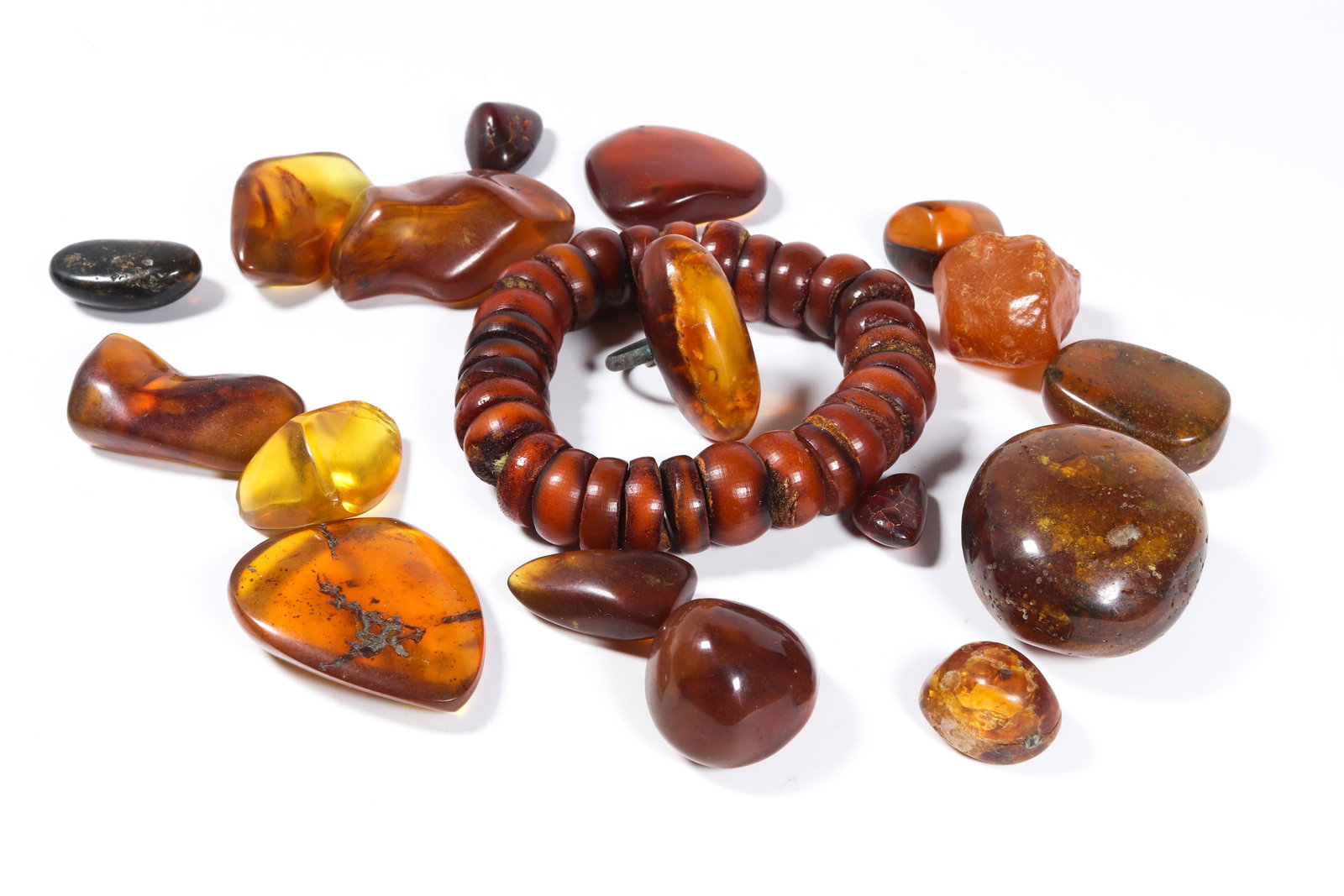 Group of amber beads: Group of amber beads, comprising sixteen small pebbles, one bracelet, and a ring, total weight 168 grams.