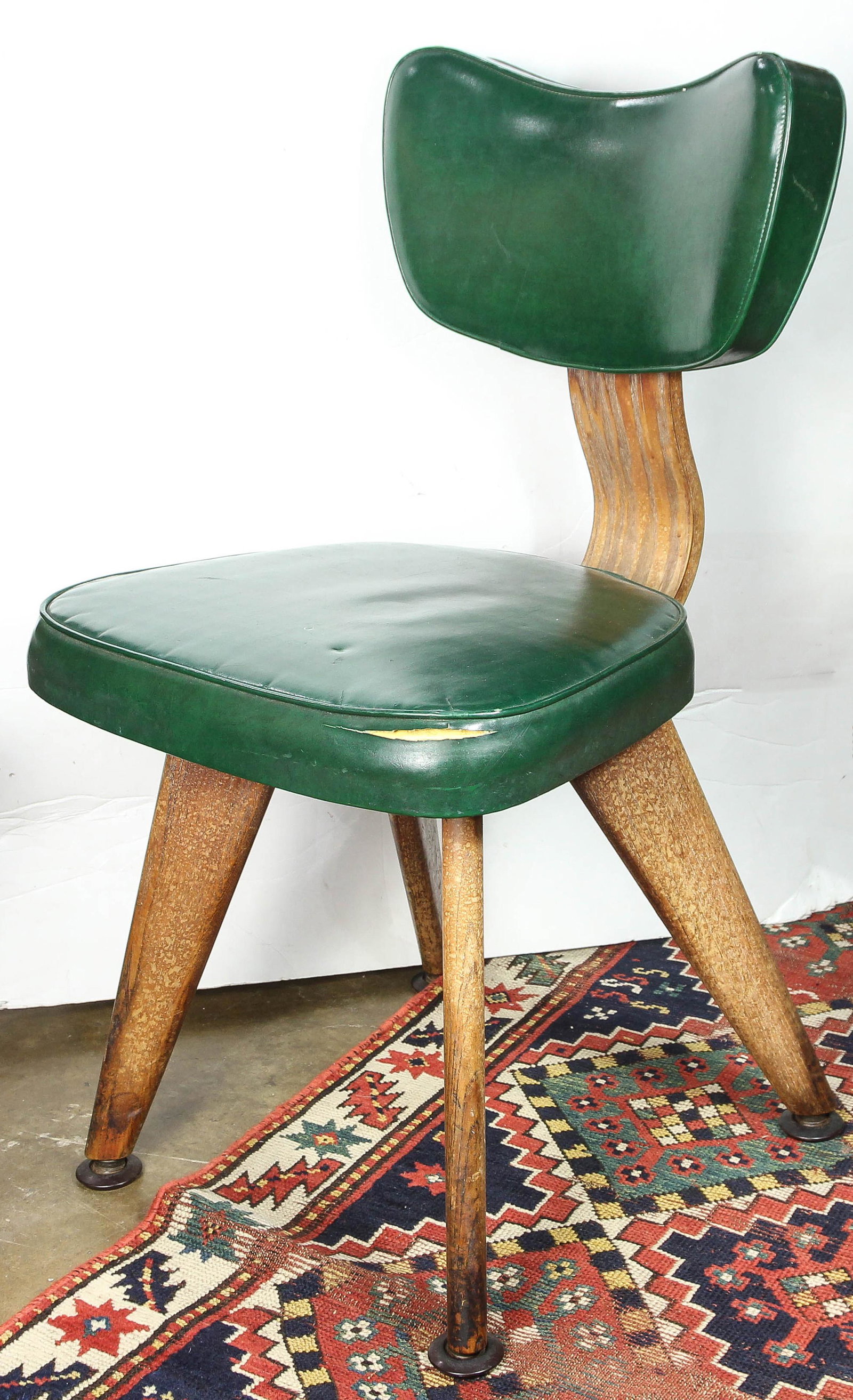 A Modern green vinyl side chair: A Modern green vinyl side chair, in the manner of Jean Prouve, 33"h