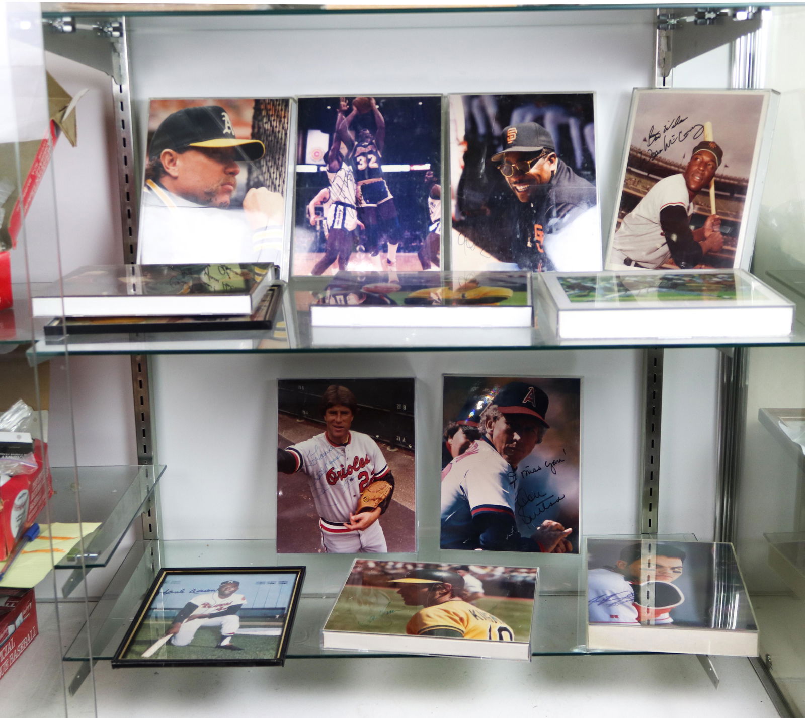 Two shelves of mostly baseball photographs bearing (1 of 3)