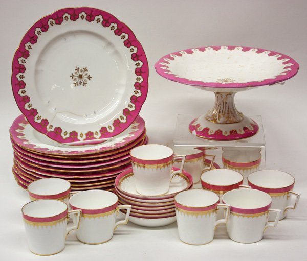 Porcelain dinnerware: Group of rose bordered and gold decorated porcelain, circa 1870, consisting of 12 dinner plates, 10 cups with 8 saucers and a compote