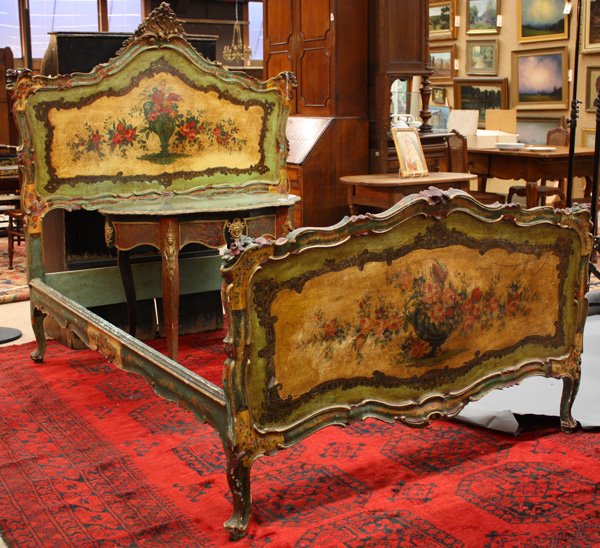 Italian Venitian style polychrome bed: Italian Venetian style polychrome bed with carved crestrail around flower painted central panel on both headboard and footboard, rails with flower painting above scalloped low relief carving, bed reta