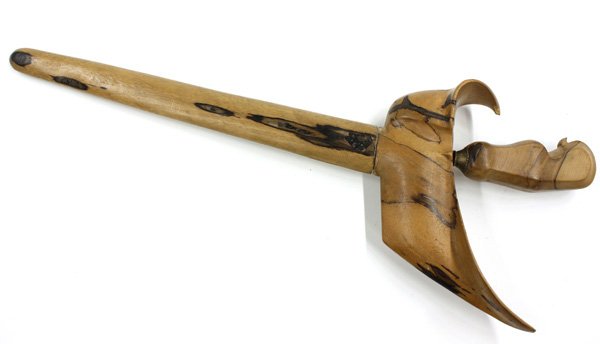 Indonesian Kris (Dagger): Indonesian metal kris (curved dagger), with the typical curving double-edged damascene blade, the hilt of stylised kingfisher form, plain wooden scabbard, overall 20.5''l; Provenance: Estate of Willia