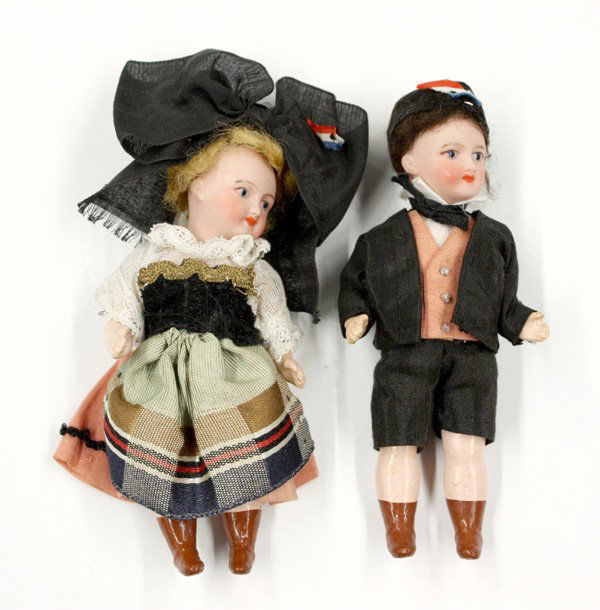 antique doll: Pair of French bisque socket head dolls with hand decorated faces on articulated composition bodys having painted brown boots, in traditional Dutch dress, marked UNIS Paris France, (wigs are loose) 5'