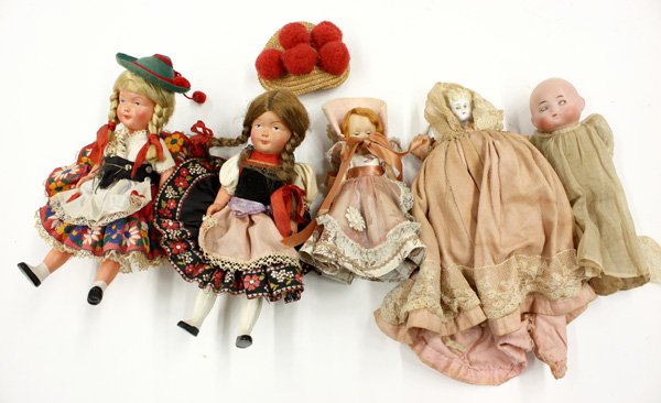 antique doll: (lot of 5) Vintage and antique dolls consisting of a German bisque solid dome doll with painted facial features, blue sleep eyes, and a closed mouth on a cloth body with composition hands 8.5'' (losse