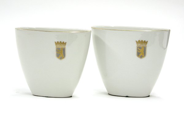 KPM porcelain vases: Pair of KPM porcelain glazed, gilt rimmed vases each with a gilt and polychrome crest, base signed with blue scepter mark and red KPM mark 5''h X 5.75''w