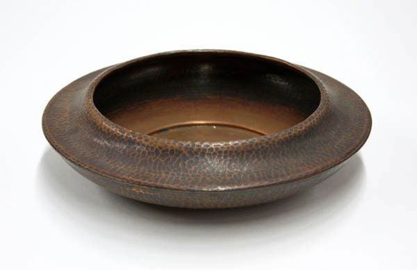 Roycroft hammered copper low bowl: Roycroft hammered copper low bowl, having a concave shoulder with a medium to dark brown original patina, impressed cross and orb mark 3''h x 11''w