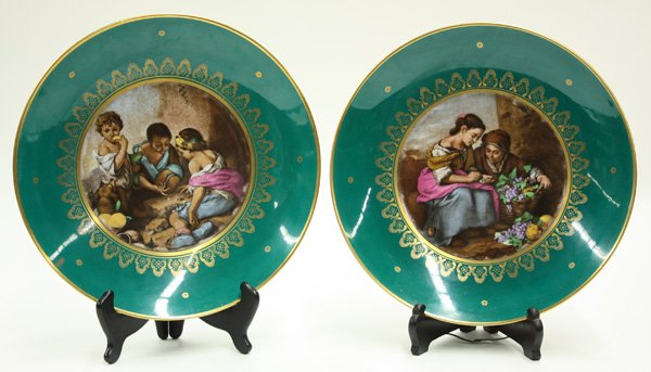 Bavarian porcelain cabinet plates: (lot of 2) Bavarian porcelain cabinet plates, both having gilt accents on an imperial green ground, each with a differing genre scene, one showing Children at play, the other with young girls with a l