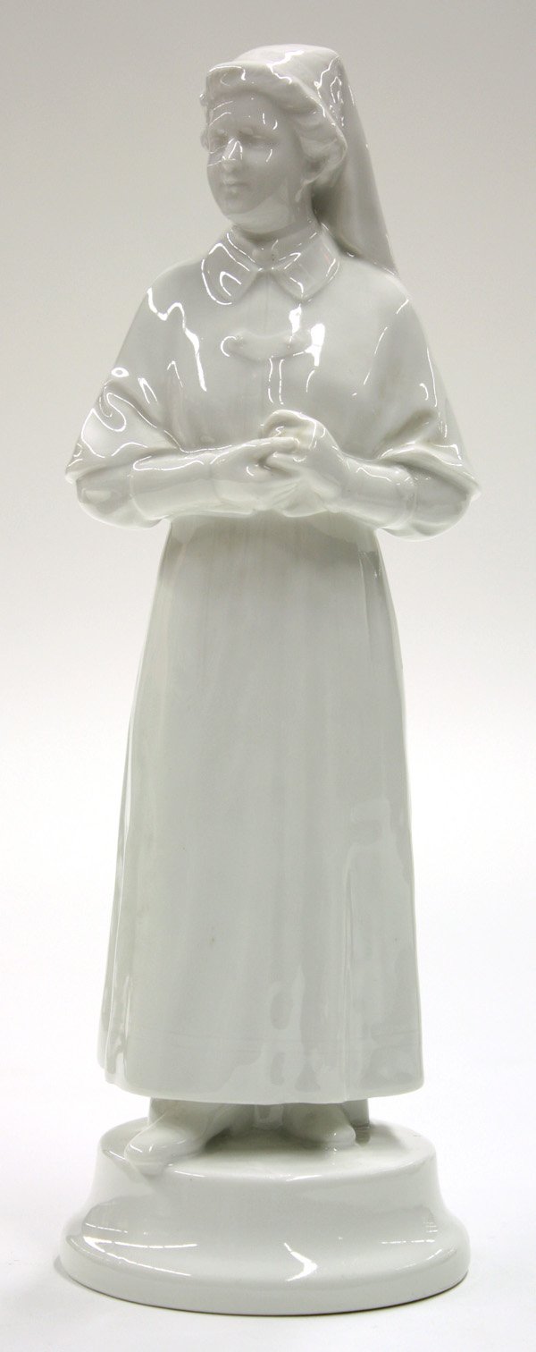 Porcelain figure of a nun: Porcelain figure of a nun having a clear glaze on white ground, of German origin, marked with iron cross and blue scepter 11''h