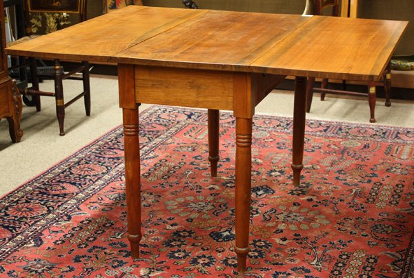 Pennsylvania walnut drop leaf table: Pennsylvania walnut drop leaf table, early 19th century, having turned legs, 28.5''h x 42''w x 19''d (48'' extended)