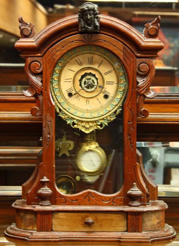 Ansonia Mantle Clock: Ansonia Clock Co. mantle clock, circa 1880, having a brass movement, the Renaissance Revival walnut case with a figural applied metal crest above a gilt and polychrome decorated bezel 20''h x 15''w x 