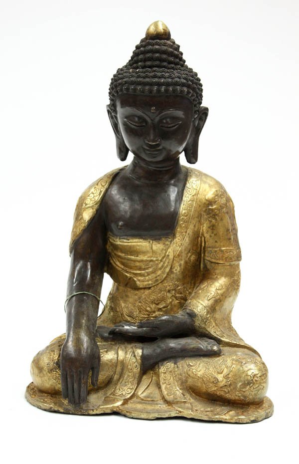 Himalayan Gilt Metal Buddha Figure: Himalayan large gilt and patinated metal figure of the Buddha, probably Nepalese, seated in dragon-patterned gilt robes in a pose of meditation, his hands in the bhumisparsa mudra of enlightenment, th