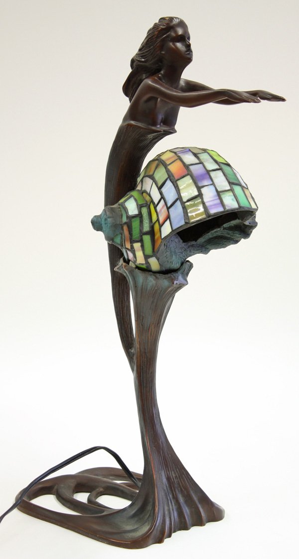 Bronze mermaid figural lamp: Bronze mermaid figural lamp with a stained and leaded glass shell form shade