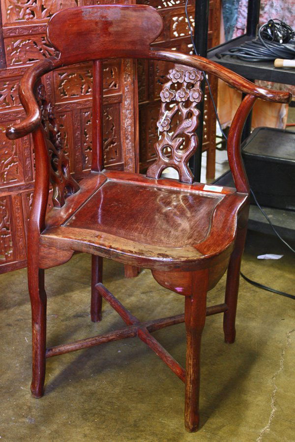 Wooden Chinese Corner Chair: Chinese wooden corner armchair, the curved arms connected to a shaped splat and joined to the square seat by bird-flower pierced panels, all rising from hoofed supports braced by cross stretchers, 34'