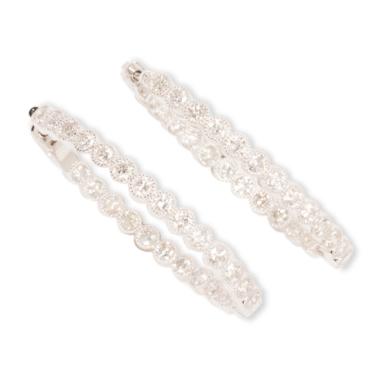 A pair of diamond and eighteen karat white gold hoop: A pair of diamond and eighteen karat white gold hoop earrings of "inside outside" design, featuring round brilliant-cut diamonds in millegrained bezels; estimated total diamond weight: 4.75 carats. 13