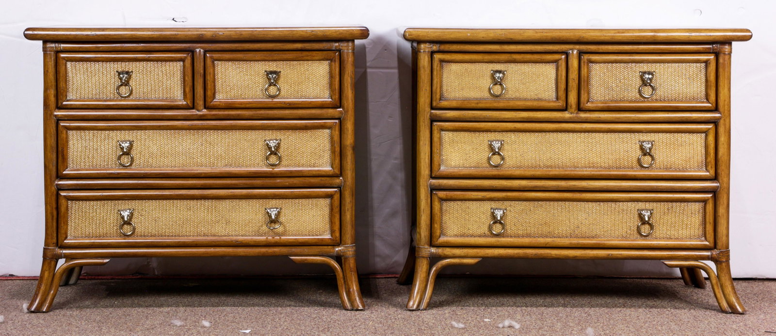 A pair of Kreiss Collection rattan nighstands: A pair of Kreiss Collection rattan nighstands, in the style of McGuire, having four drawers, and rising on outswept legs, 26"h x 32"w x 17"d Provenance: Estate of Frank J. Caufield (San Francisco, CA)