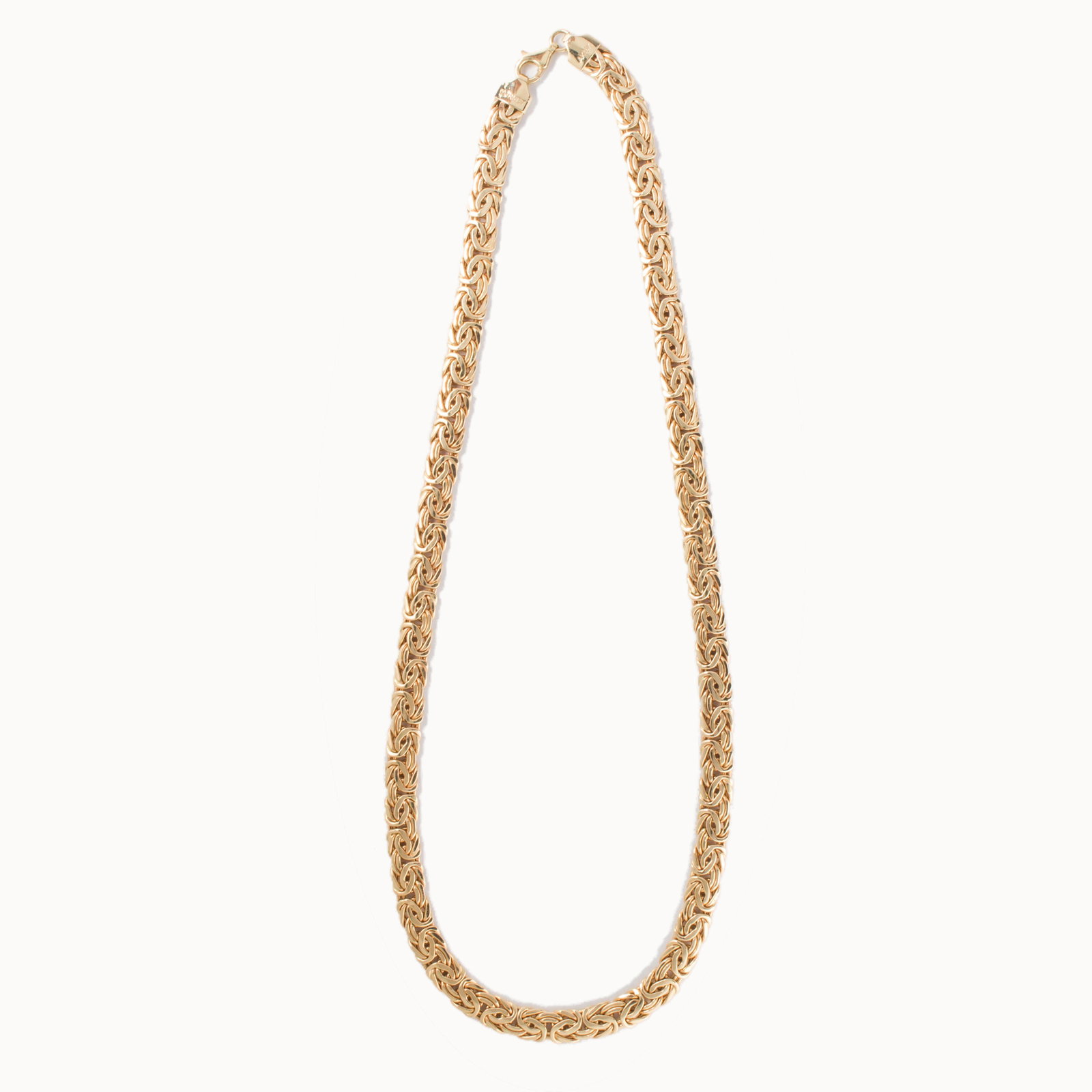 A fourteen karat gold necklace: A fourteen karat gold necklace designed as byzantine link chain. 12.1 dwt; length: 18 in