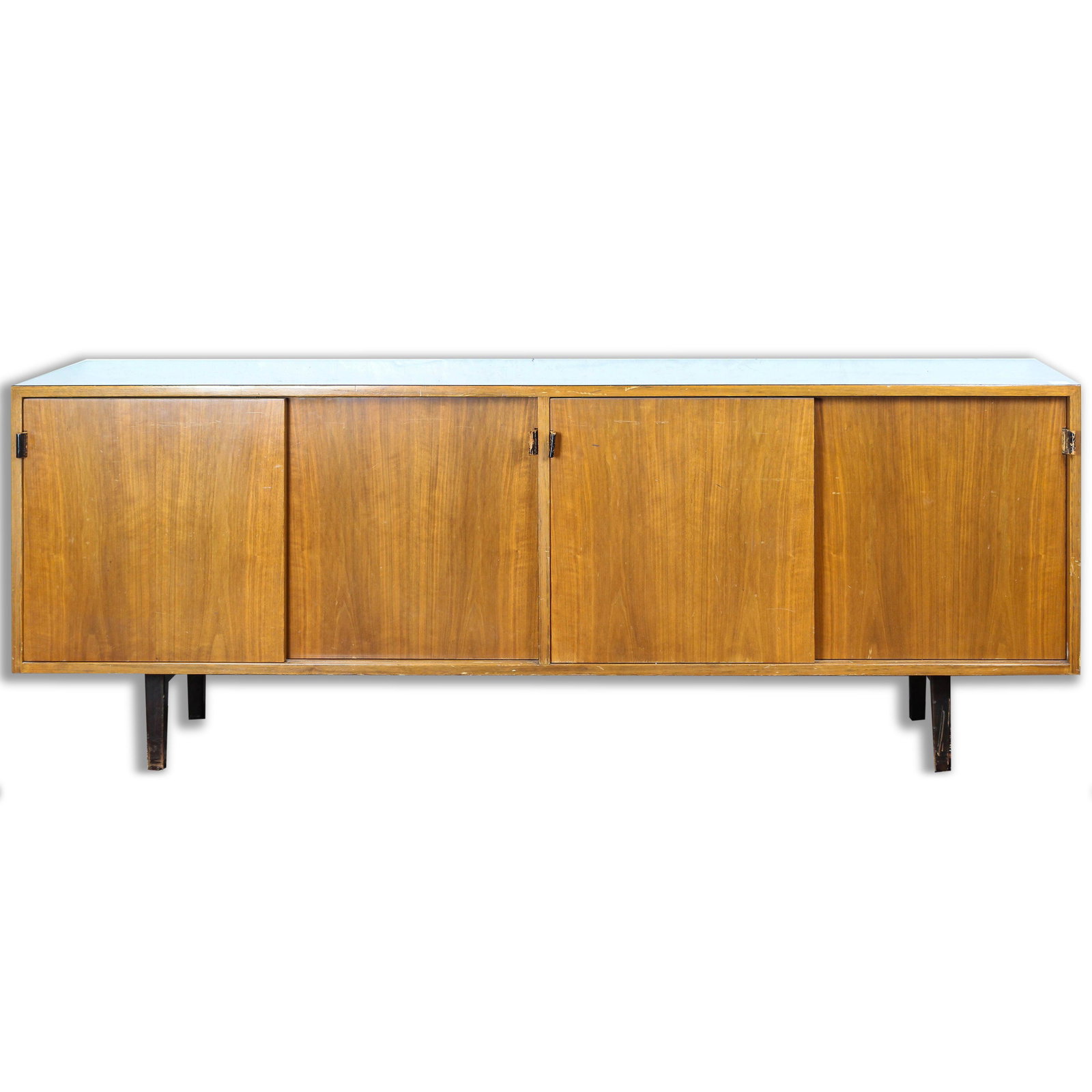 A Florence Knoll for Knoll Associates credenza: A Florence Knoll for Knoll Associates credenza, having a rectangular top above sliding doors with leather pulls and rising on tapered legs, with label verso, 28"h x 72"w x 18"d