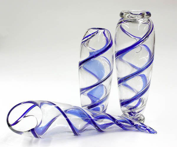 Oggetti Murano art glass vessels: (lot of 3) Oggetti Murano art glass vessels executed in clear glass with cobalt blue spirals, in cornucopia and ovoid forms, signed to bases, the longest 24''l