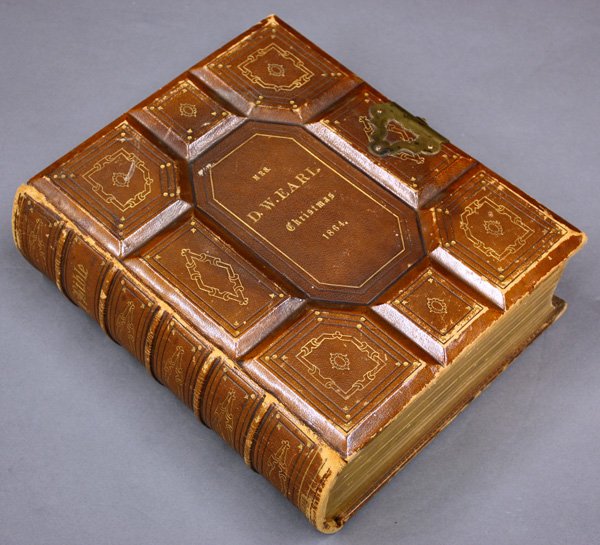 1864 Holy Bible presented to D.W Earl: 1864 Holy Bible presented to D.W Earl, printed in Philadelphia and having tooled leather contemporary boards, and gilt scroll designed end pages, affixed to the inner page is a signed note by Vice pre