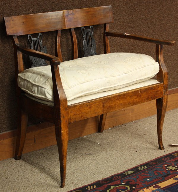 French Empire provincial walnut two seat settee: French Empire provincial walnut two seat settee, having ebonized lyre back double splats and cabriole legs, damage to one splat, circa 1820, 34''h x 36''w x 21''d